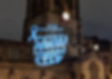 "25th November White Ribbon Day" projected onto church tower