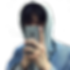 Boy in hoodie holding up a phone that blocks his face
