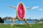 Woman in vulva costume doing yoga next to a lake